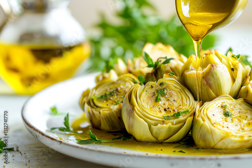 Grilled artichoke hearts drizzled with olive oil and garnished with fresh herbs. Freshly cooked artichoke hearts are served on a plate, generously drizzled with olive oil and sprinkled with herbs