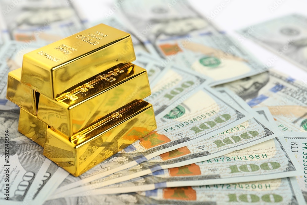 Stack of shiny gold bars on dollar banknotes, closeup. Space for text Stack of shiny gold bars on dollar banknotes, closeup. Space for text