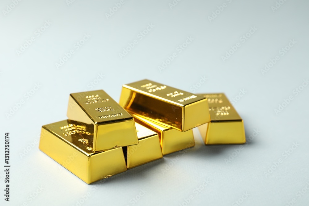Shiny gold bars on light grey background, closeup Shiny gold bars on light grey background, closeup