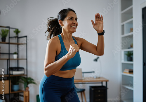 Obraz na płótnie Smiling woman practicing online fitness class at home, enjoying healthy lifestyle w salonie
