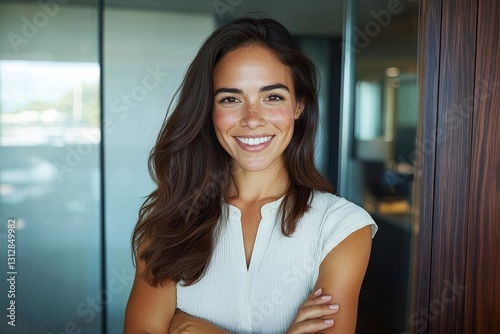 A 45-year-old Latin professional woman, exuding confidence with a smile, stands in her office with her arms crossed, looking directly at the camera as a portrait of a mature female corporate leader Free Download A 45-year-old Latin professional woman, exuding confidence with a smile, stands in her office with her arms crossed, looking directly at the camera as a portrait of a mature female corporate leader - GFXLoad