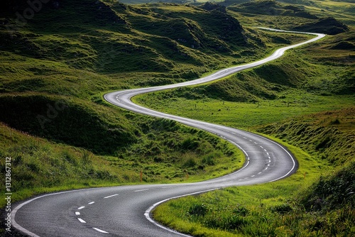 A curving mountain road set against a cloudy sky creates a scenic view