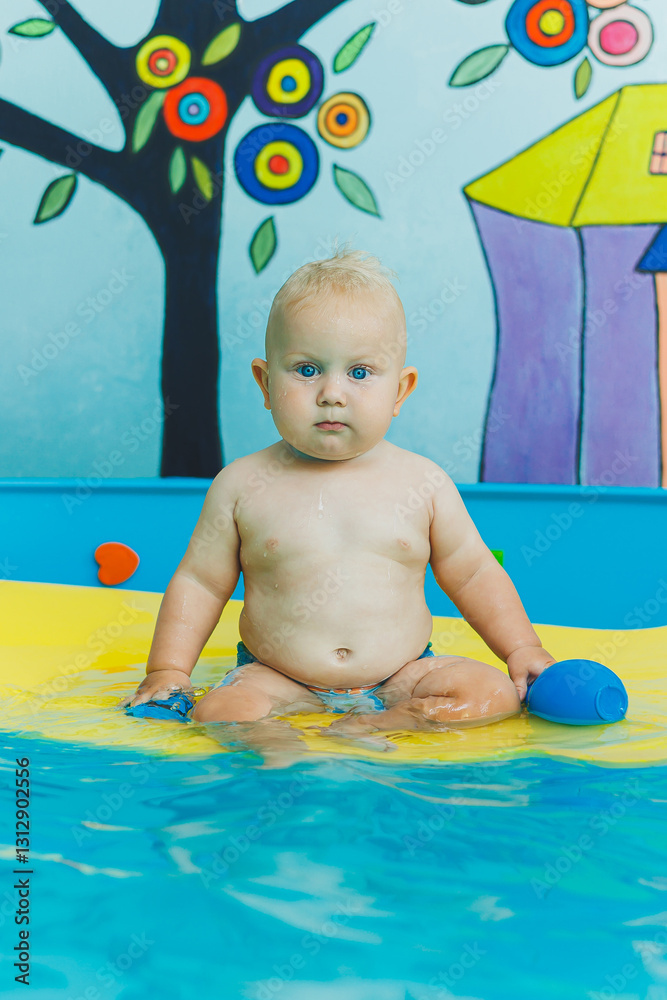 Child learns to swim with coach in pool. Swimming in children's pool. Happy child with coach in indoor pool playing and having fun. Child learns to swim with coach in pool. Swimming in children's pool. Happy child with coach in indoor pool playing and having fun.