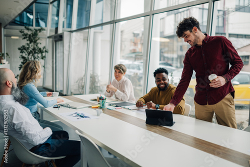 Creative business team sharing ideas during meeting in modern office