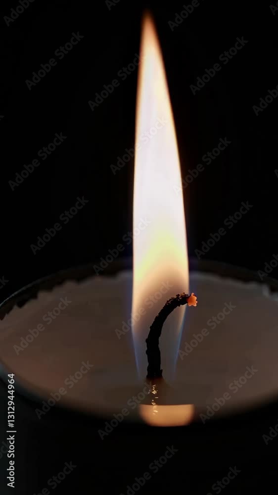 A gentle candle flame flickers, casting a warm glow in a dark room, creating an atmosphere perfect for relaxation and contemplation. Ideal for enhancing cozy moments or meditation. A gentle candle flame flickers, casting a warm glow in a dark room, creating an atmosphere perfect for relaxation and contemplation. Ideal for enhancing cozy moments or meditation.