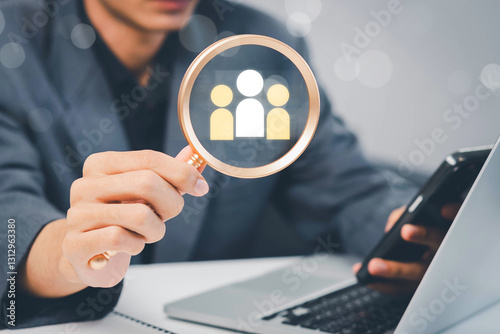 Fototapeta Naklejka Na Ścianę i Meble -  Businessman use magnifying glass to find human icon for business CRM or Customer Relation Management and customer focus target group concept, social media. Digital marketing online. HRM, human manage.