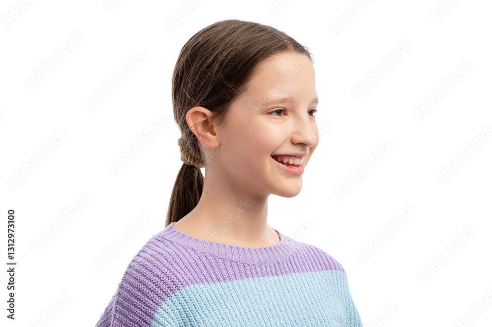 A young girl with a ponytail smiling against a white background. A young girl with a ponytail smiling against a white background.