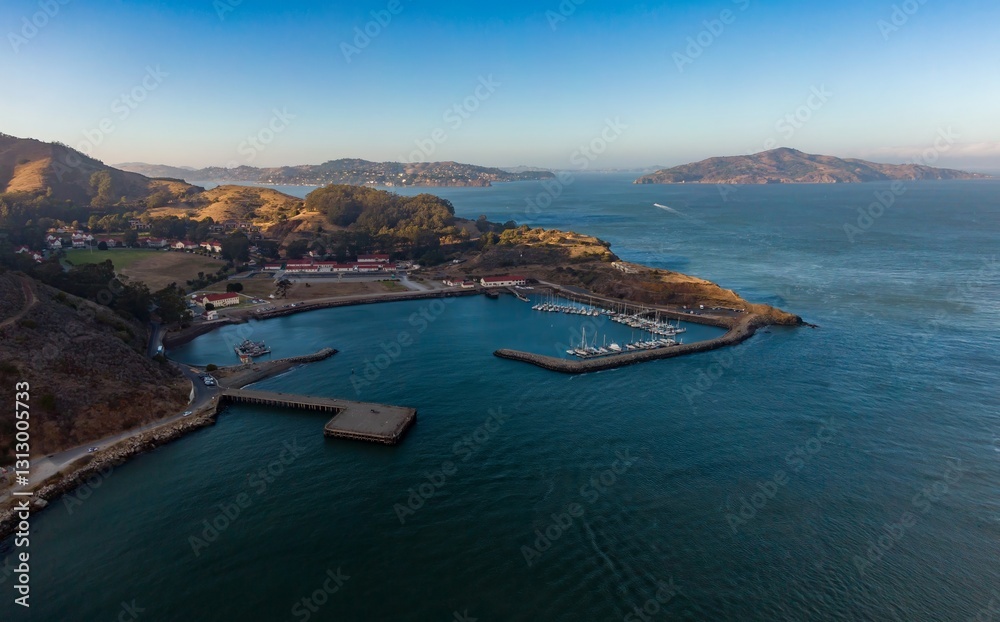 Aerial view of Fort Baker, a former US Army post, now part of the Golden Gate National Recreation Area, in Sausulito, California, USA. Sailboats are docked in the harbor at Horseshoe Bay. Aerial view of Fort Baker, a former US Army post, now part of the Golden Gate National Recreation Area, in Sausulito, California, USA. Sailboats are docked in the harbor at Horseshoe Bay.