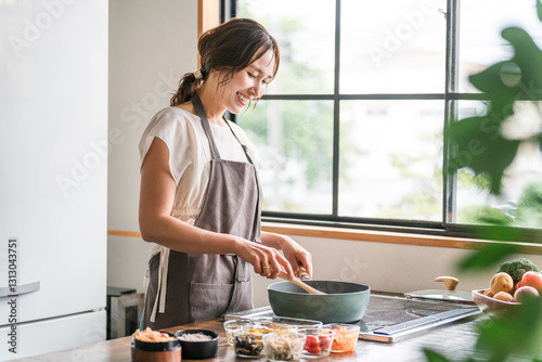 キッチンで料理をする若いアジア人女性（クッキング・手料理）
 photo