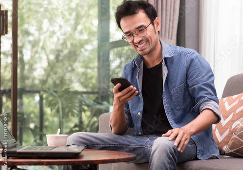 happy man using smartphone during sitting at home or cafe