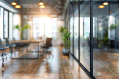 Sunlight illuminates a blurred modern office interior showcasing a wooden floor  glass walls  and a conference table  creating a bright and spacious atmosphere
