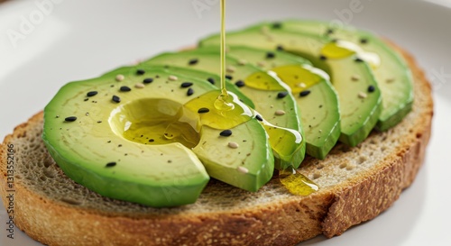 Avocado Toast with Olive Oil and Sesame Seeds Being Prepared photo