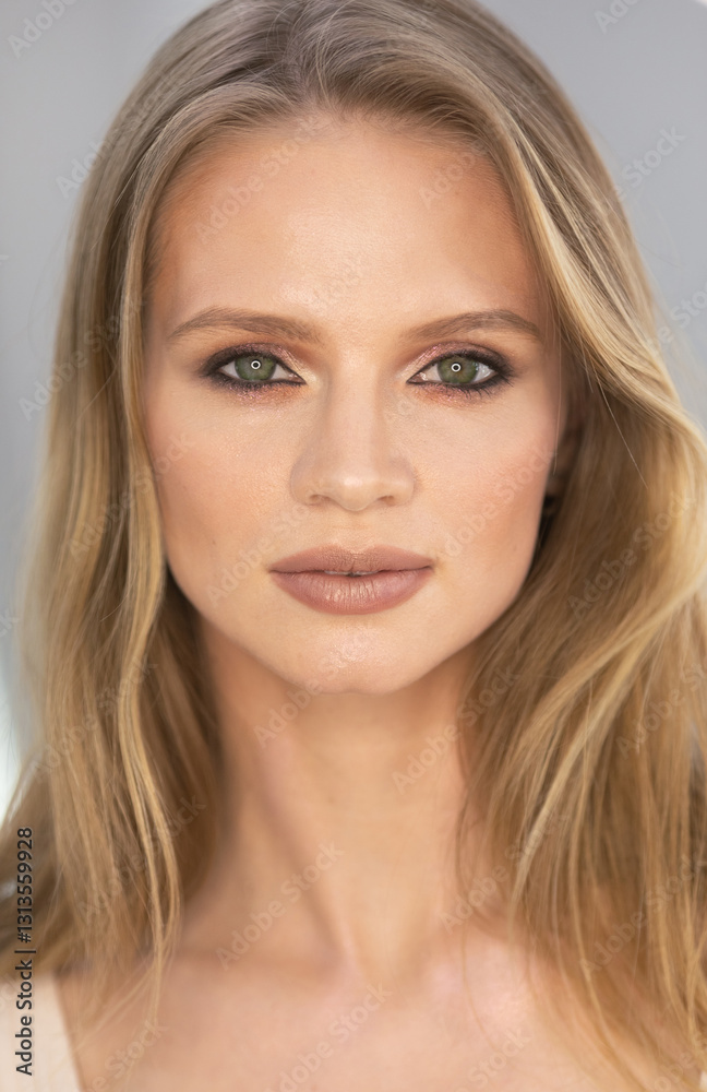 blonde woman with green eyes and a tan complexion. She is wearing a tan shirt and has a light brown hair blonde woman with green eyes and a tan complexion. She is wearing a tan shirt and has a light brown hair