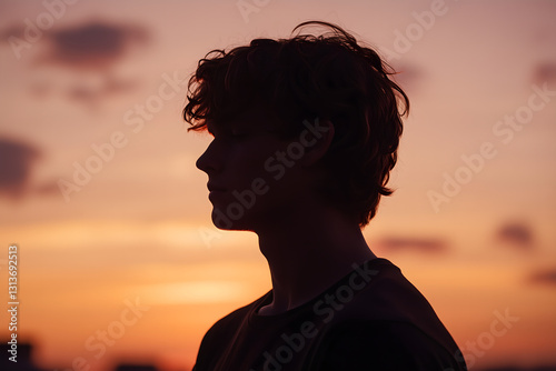 Man , Young man outdoors at sunset feeling relax, Young man silhouette, portrait in profile on sunset light, Wanderlust guy under sunset
