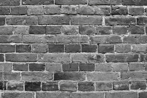 Wall background of dark grey bricks. Grey brick wall background. Dark grey wall closeup.