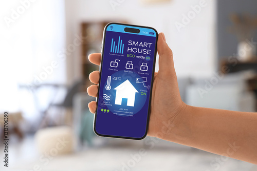 Woman with blank mobile phone at home, closeup