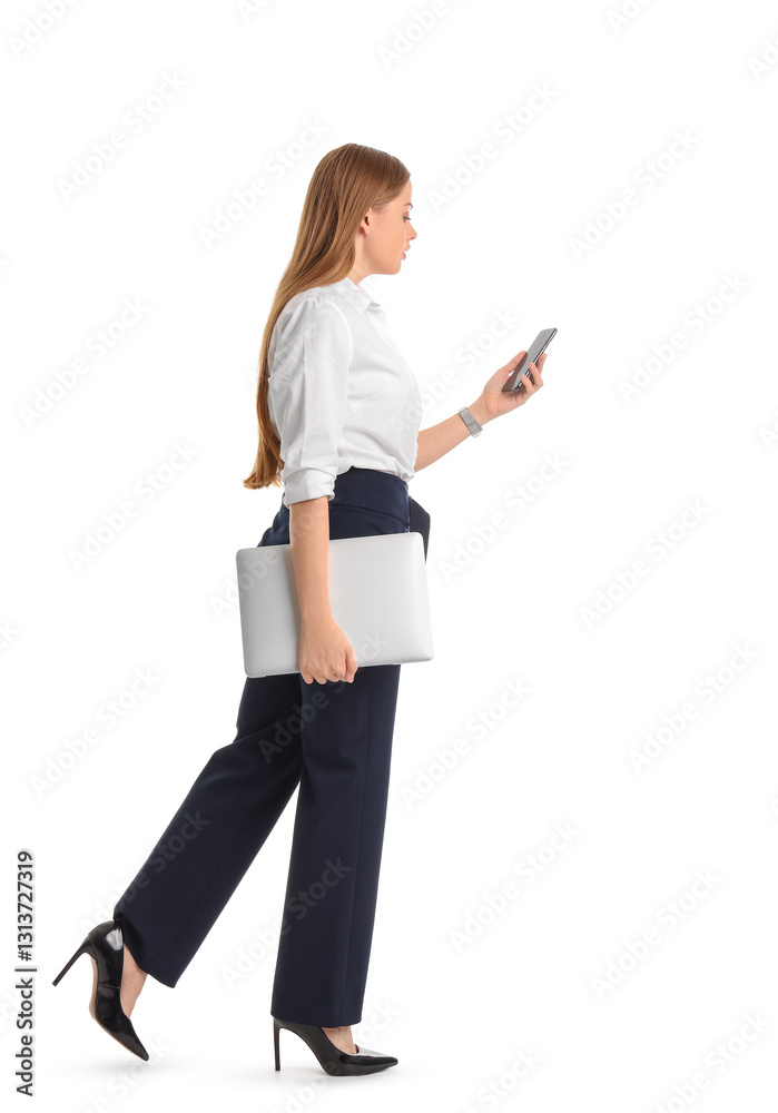 Pretty young businesswoman with laptop and mobile phone walking forward on white background Pretty young businesswoman with laptop and mobile phone walking forward on white background