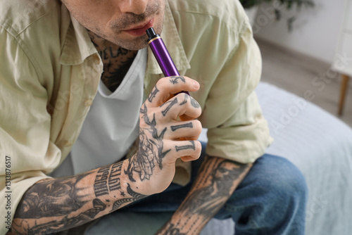 Young tattooed man smoking ...