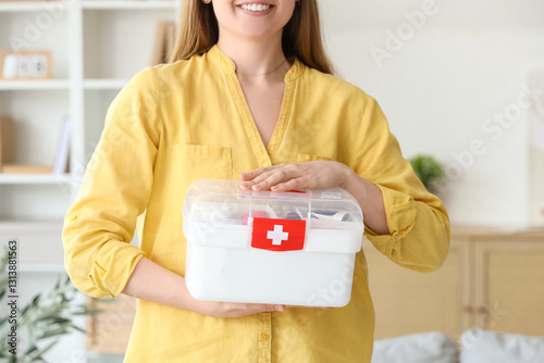 Woman with first aid kit at...