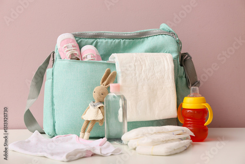 Baby bag with shoes on tabl...