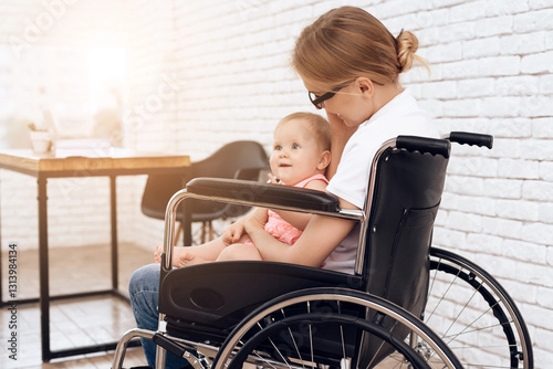 Disabled mother in wheelchair with newborn baby.