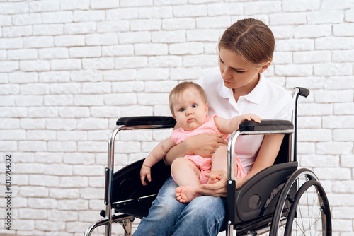 Disabled mother in wheelchair with newborn baby. photo