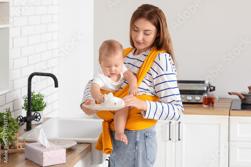 Young mother wearing a baby...