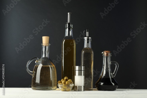 Wallpaper Mural Salad dressings, olives and salt on white wooden table against black background Torontodigital.ca