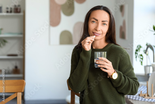 Beautiful woman taking pill...