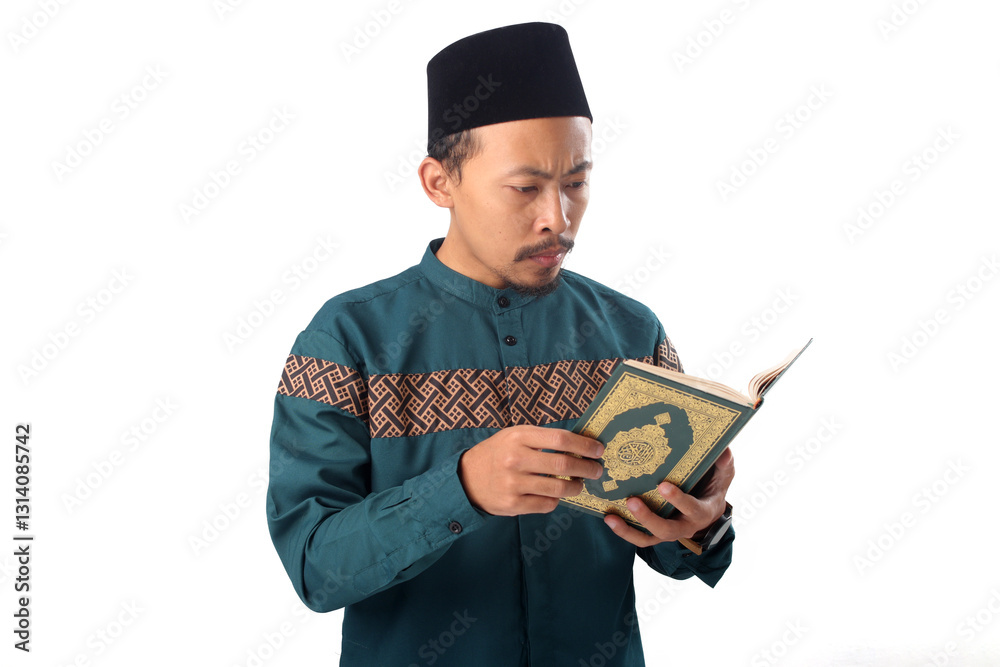 Asian Muslim man flipping through the Holy Quran and reciting during Ramadan, isolated on a white background Asian Muslim man flipping through the Holy Quran and reciting during Ramadan, isolated on a white background