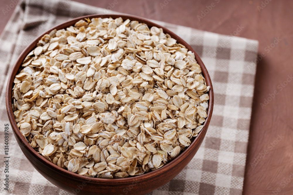 Bowl of Oat Flakes on Linen Napkin, Close-Up Bowl of Oat Flakes on Linen Napkin, Close-Up