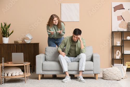 Angry wife scolding her hus...