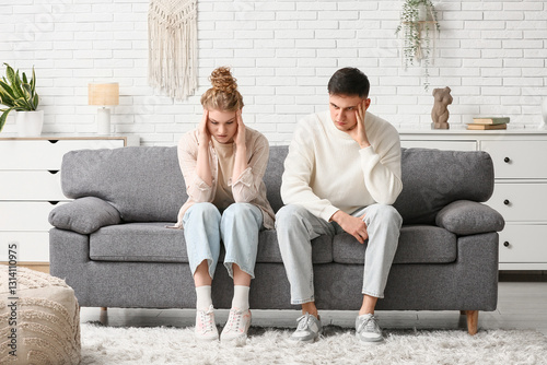 Upset young couple after quarrel at home
