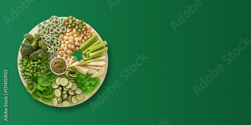 Obraz na płótnie St Patricks day charcuterie board decorated shamrock on green background. View from above. Banner. Copy space. w salonie