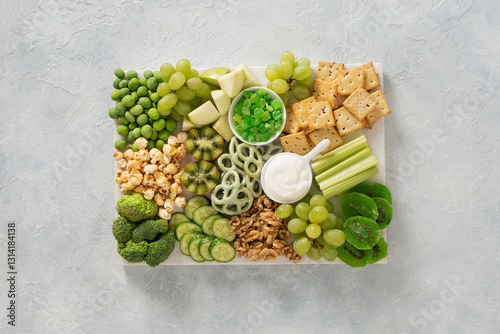 Obraz na płótnie St Patricks day charcuterie board with green fruit and vegetables on light background. View from above. Festive holiday appetizer for celebration. w salonie