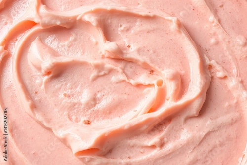 Close-up photograph of creamy pink ice cream with vanilla swirl, dark specks, smooth texture, and bright lighting highlighting indulgent appearance