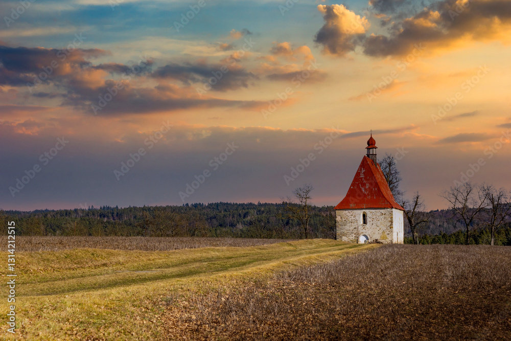 Sunset over old church in the field. Dobronice u Bechyne, Czechia