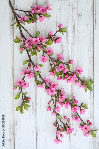 Vertical Two spring flowering branches with a lot of pink blossoms on white wooden background. Rustic composition.
