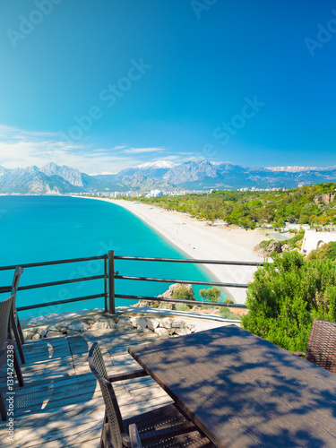 Fototapeta Naklejka Na Ścianę i Meble -  Konyaaltı Beach in Antalya, Turkey, serene turquoise waters of Mediterranean sea, blue sky, and lush greenery. Welcome to Antalya concept image