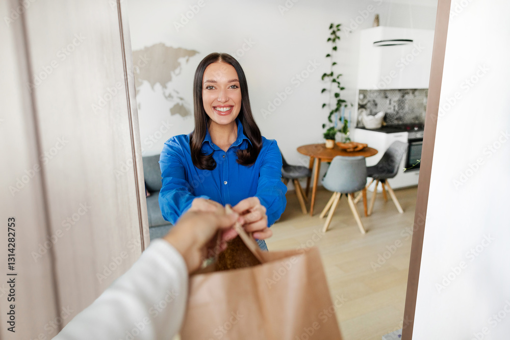 Delivery courier delivering bag with food to happy woman at home. Online food shopping service concept Delivery courier delivering bag with food to happy woman at home. Online food shopping service concept