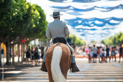 Malaga, Andalusia, Spain - August, 12, 2018: riders walk through the Real de la Feria, Feria de Málaga