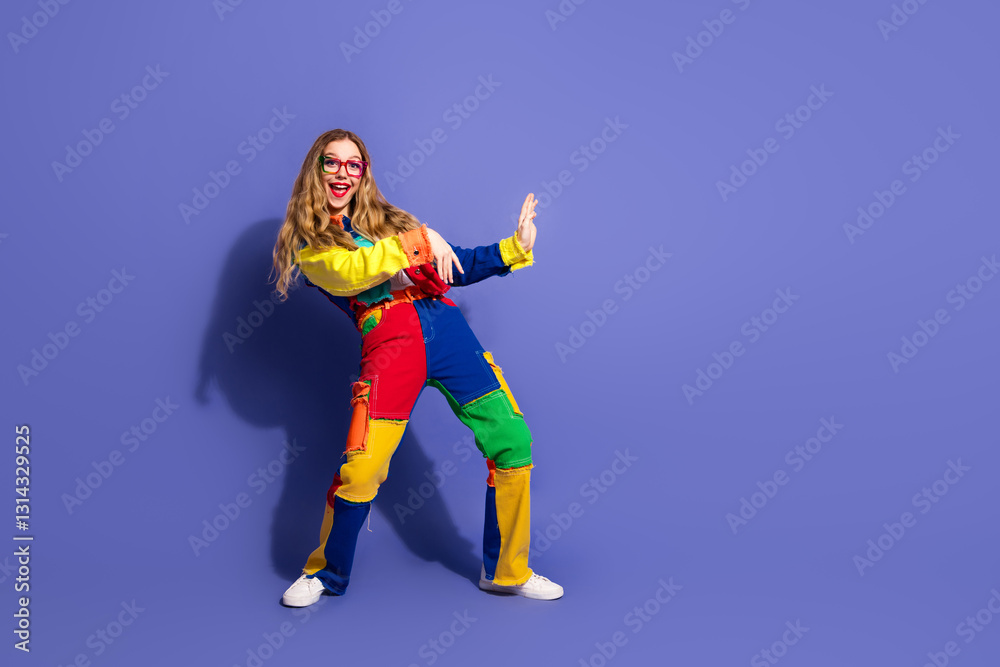 Fashionable young woman posing in a colorful outfit against a violet background, showcasing cheerful expressions and stylish gestures Fashionable young woman posing in a colorful outfit against a violet background, showcasing cheerful expressions and stylish gestures