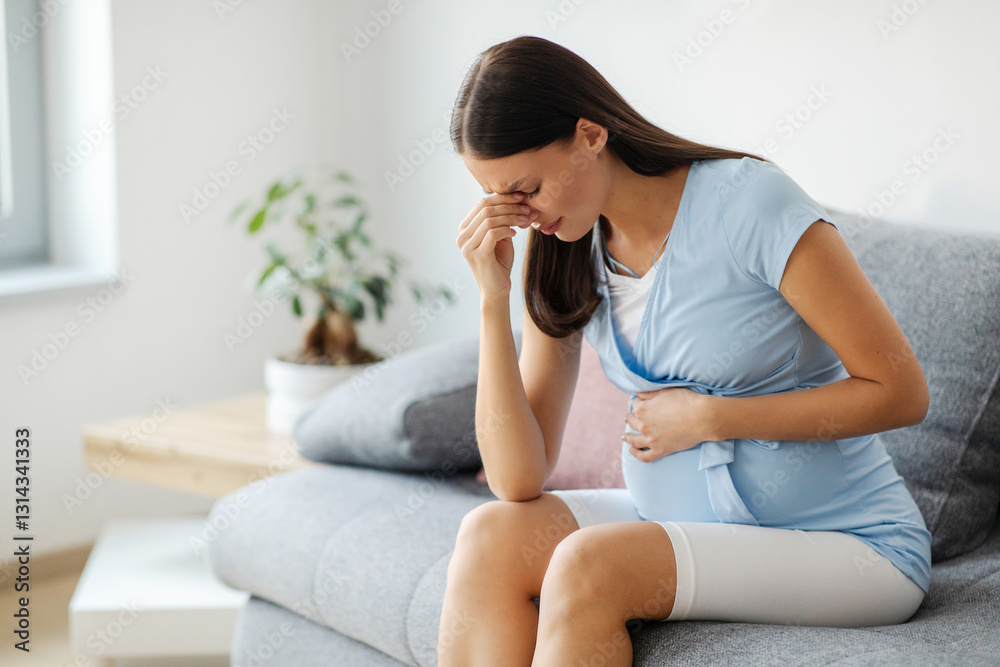 Pregnant woman feeling unwell, having headache, sitting on sofa at home, free space. Health problems during pregnancy concept Pregnant woman feeling unwell, having headache, sitting on sofa at home, free space. Health problems during pregnancy concept