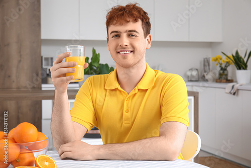 Young man with glass of ora...