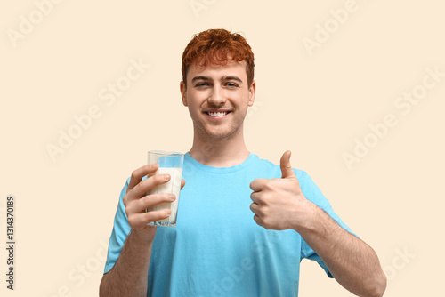 Young man with glass of mil...