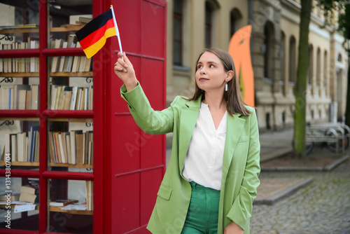 Young woman with flag of Ge...