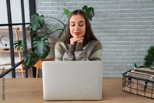 Young woman with laptop vid...