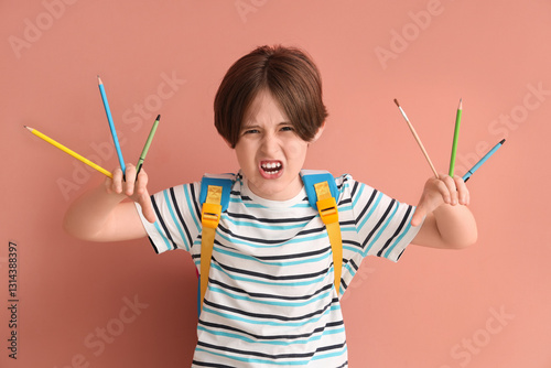 Angry little boy with backp...