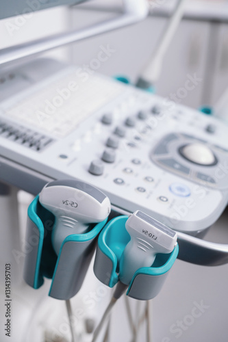 Ultrasound equipment close-up on white background. Modern medical equipment. An ultrasound machine and a couch. Medical equipment background, close-up ultrasound machine. Selective focus
