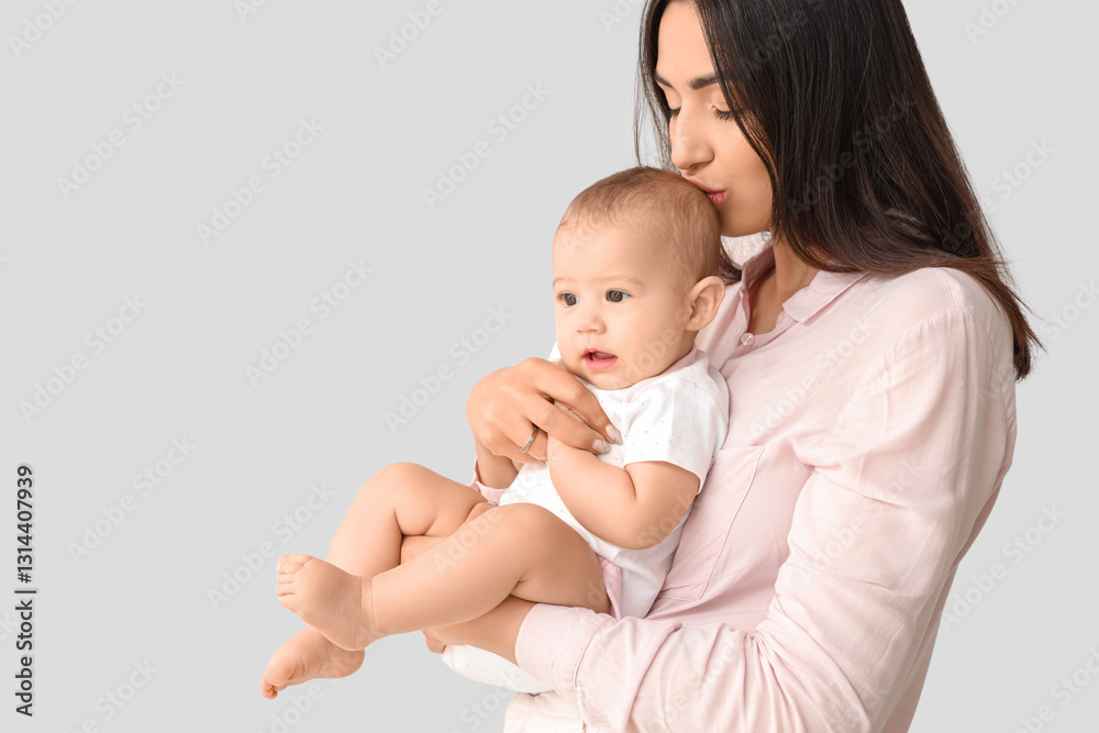Happy mother with her little baby on light background Happy mother with her little baby on light background